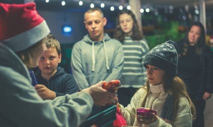 Adult handing some Christmas presents